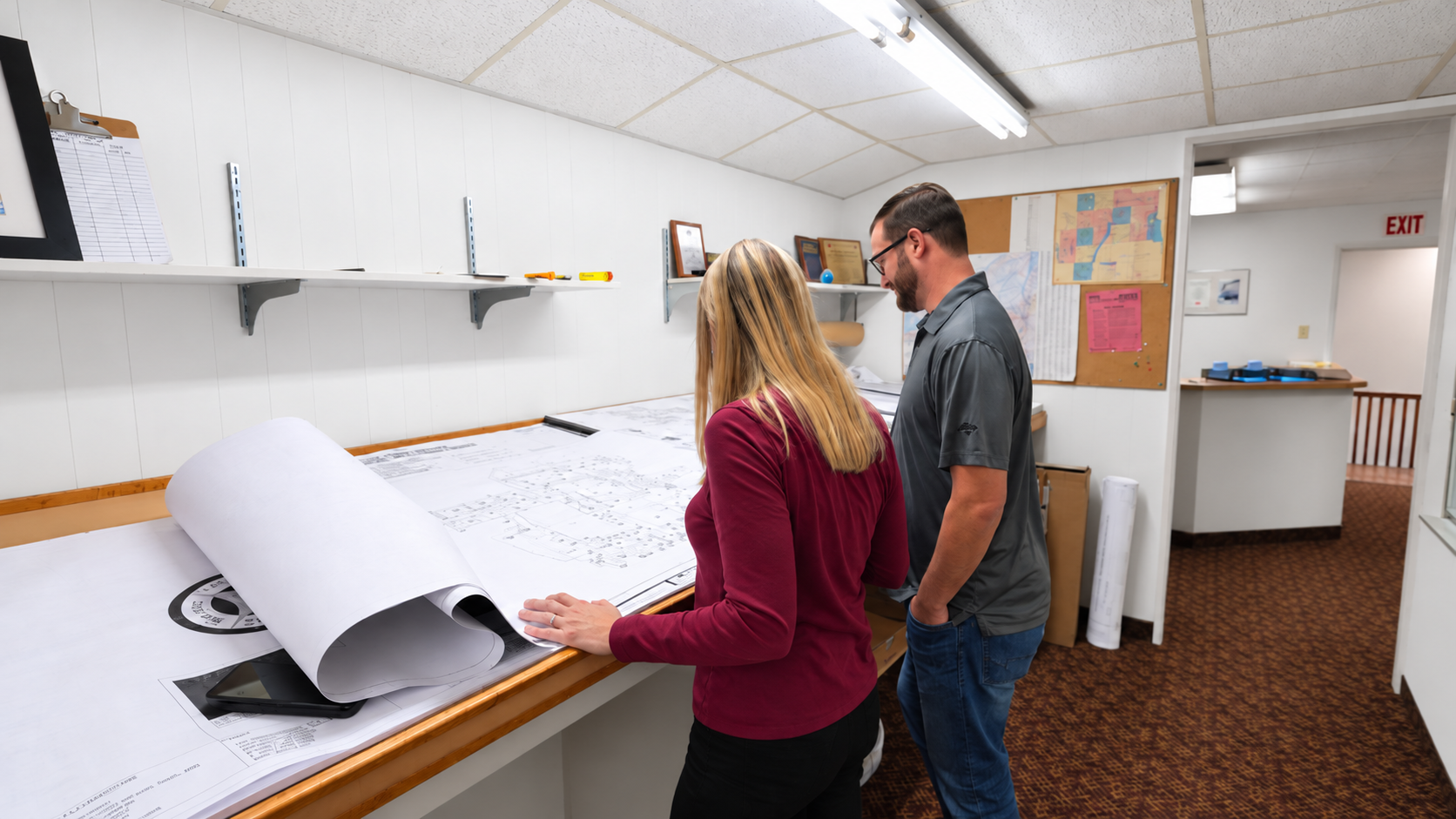 Team members reviewing blueprints together in the Iversen office