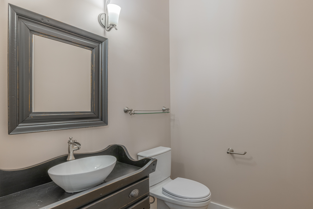 Powder room with vessel sink and framed mirror