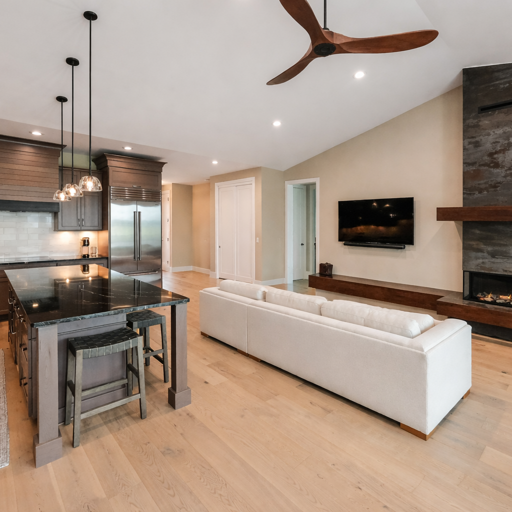 Open-concept great room with vaulted ceiling, white oak floors, and island seating