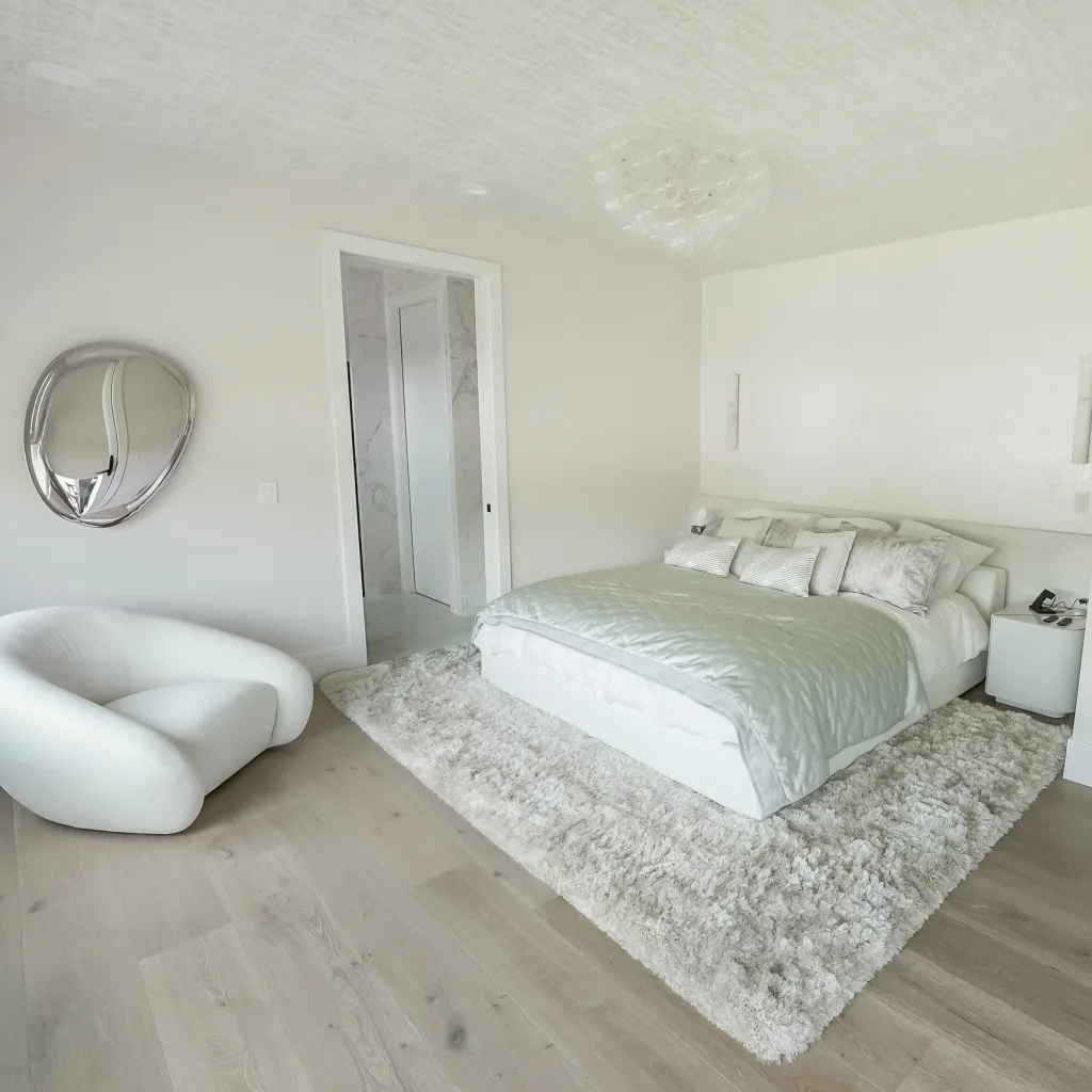 Primary bedroom with light oak flooring and en-suite entry
