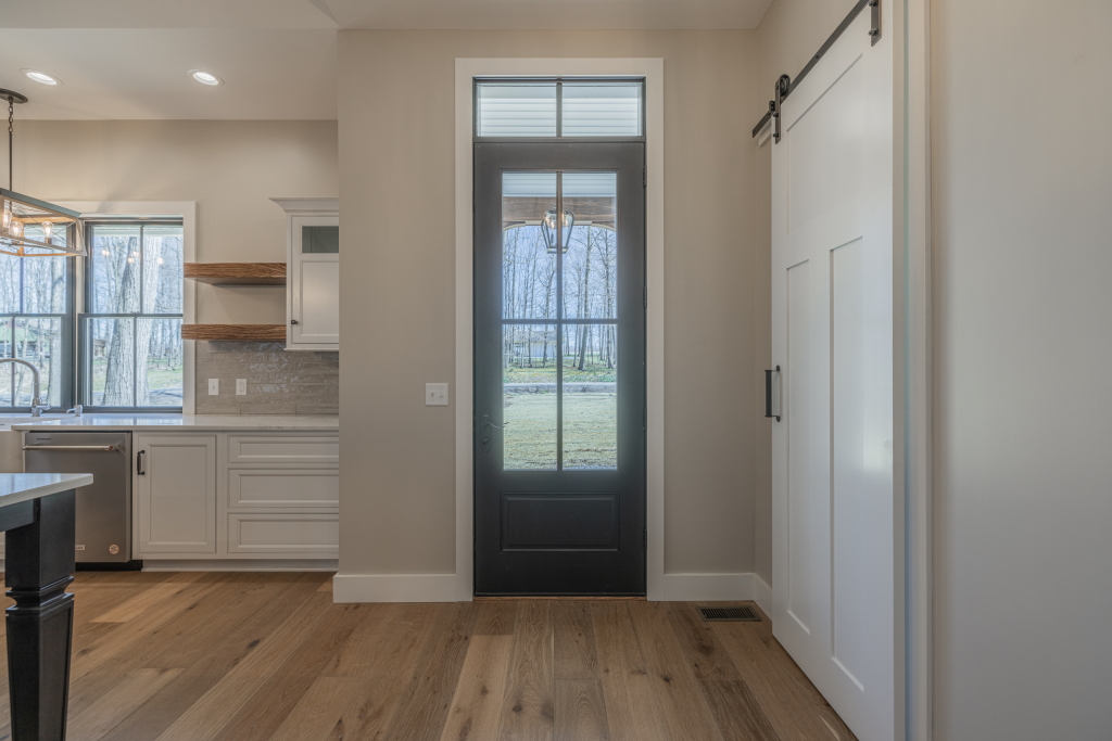 Entry hallway with glass-panel door and barn door