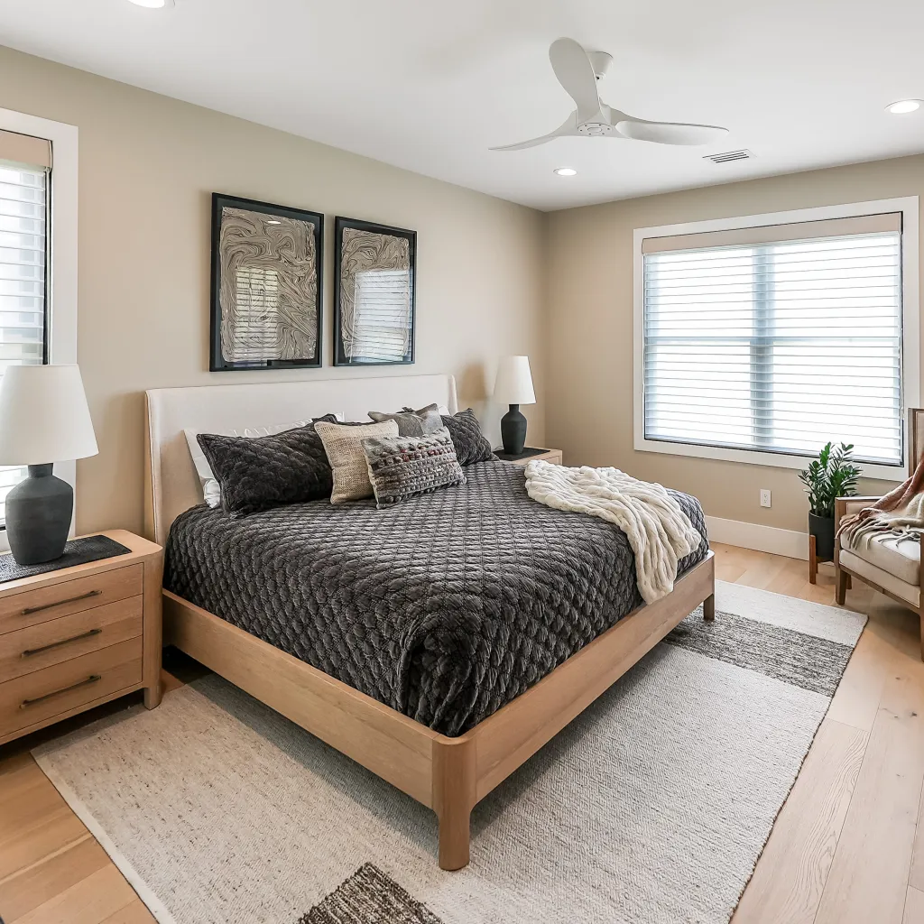 Primary bedroom with natural light and layered textiles