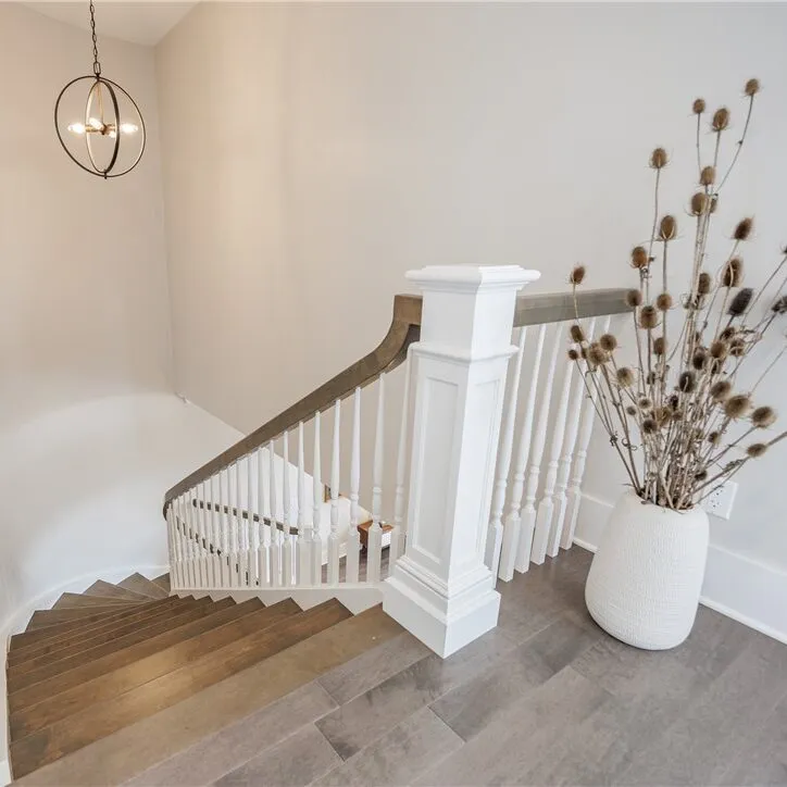 Curved staircase with wood treads and painted railing