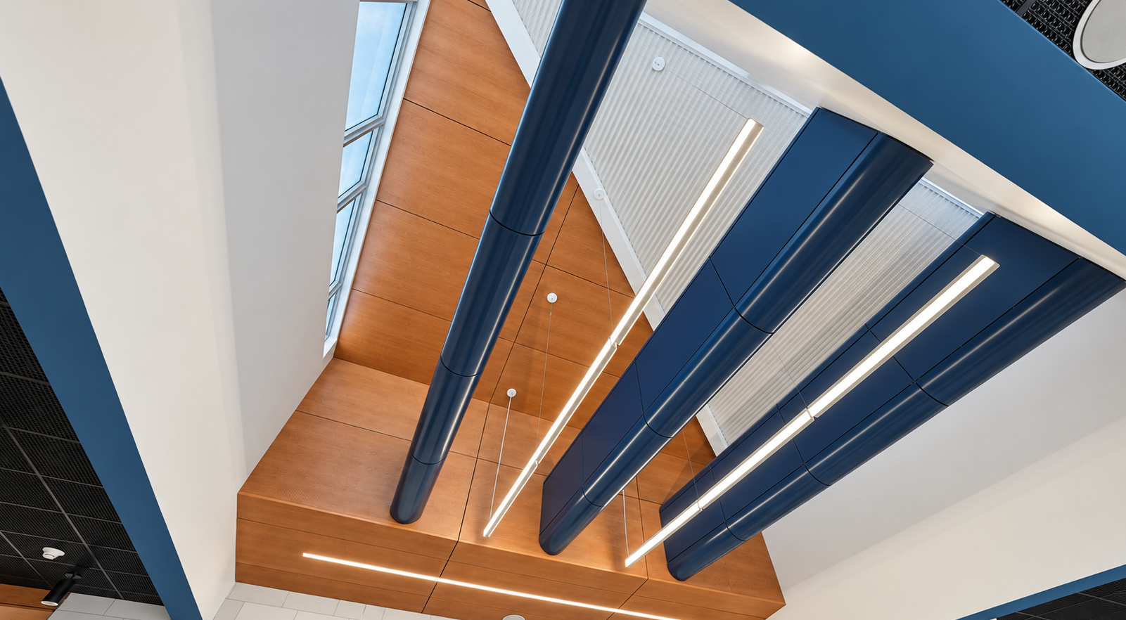 Wood ceiling detail with suspended lighting at Bath Central School District