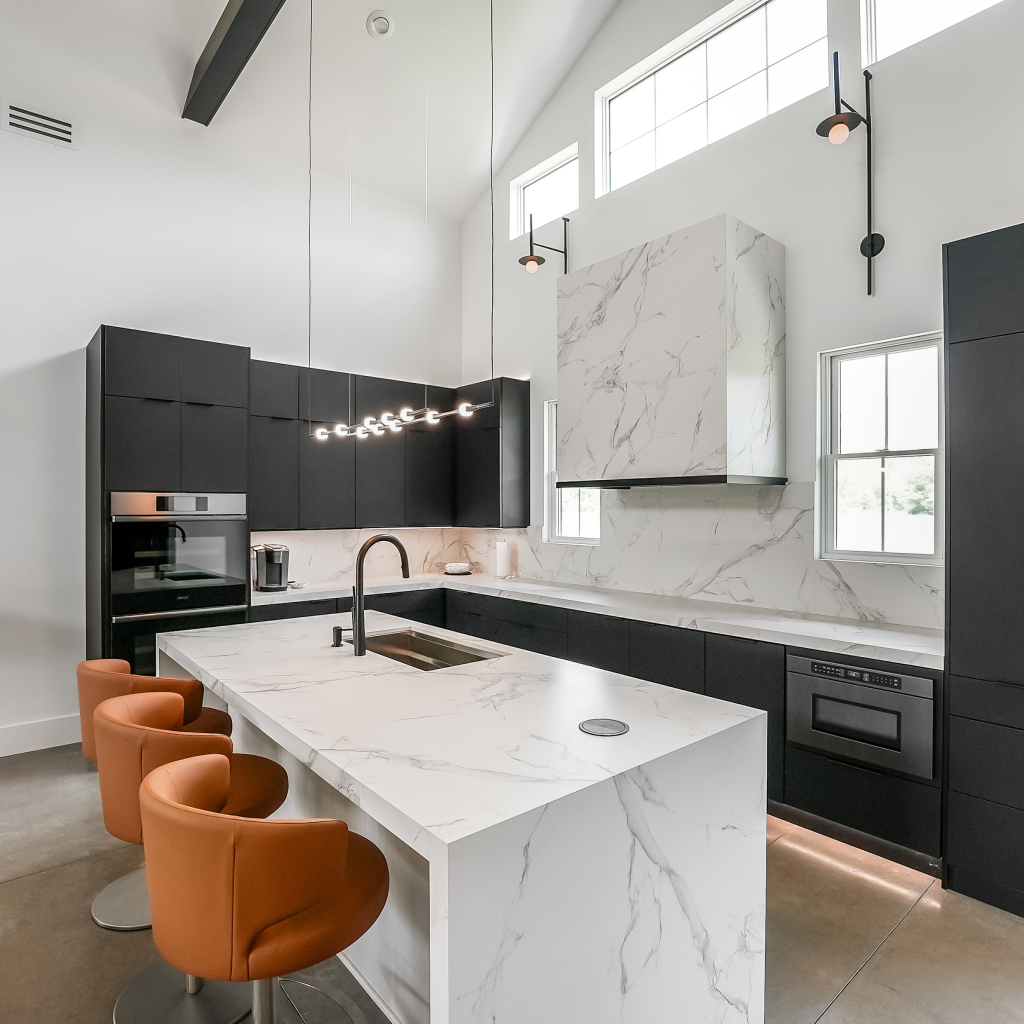 The Stevedore kitchen with waterfall stone island and black cabinetry
