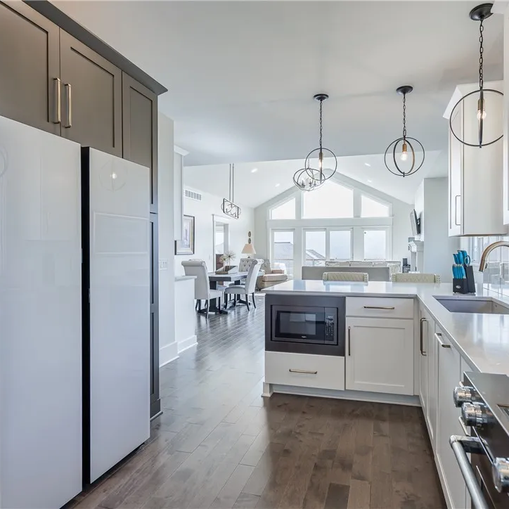 Open-concept kitchen and great room with cathedral ceilings and lake-facing windows
